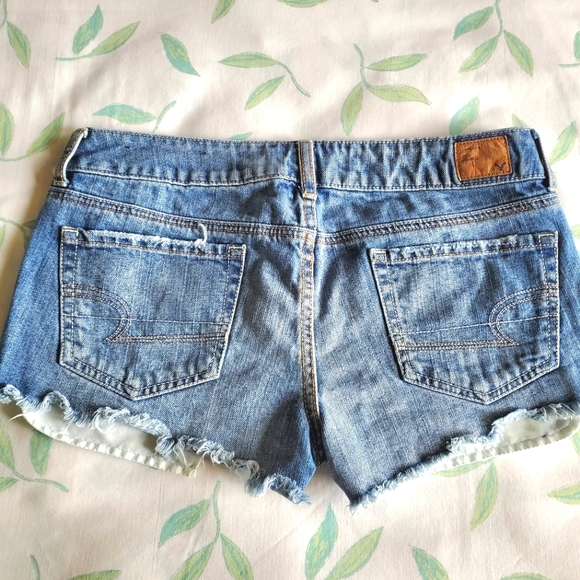 American Eagle High Waist Cut-Off Denim Shorts with Silver Glitter Star Pockets - Picture 6 of 9
